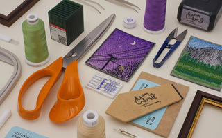 All the essential tools required for machine embroidery, including a sewing machine, embroidery hoops, threads, stabilizers, and fabric, displayed neatly for a comprehensive guide on machine embroidery.